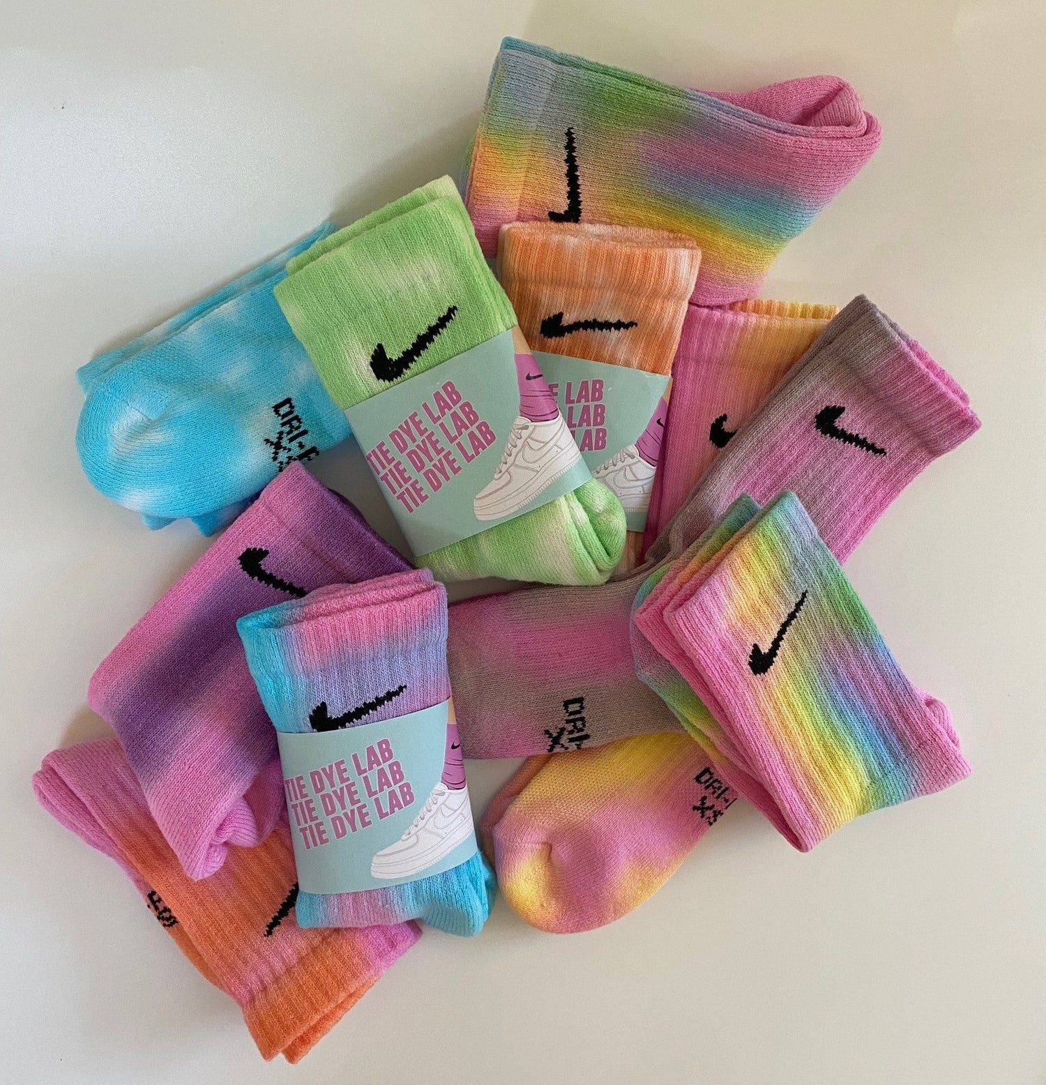 A group of kids size Nike tie dye socks in various colours