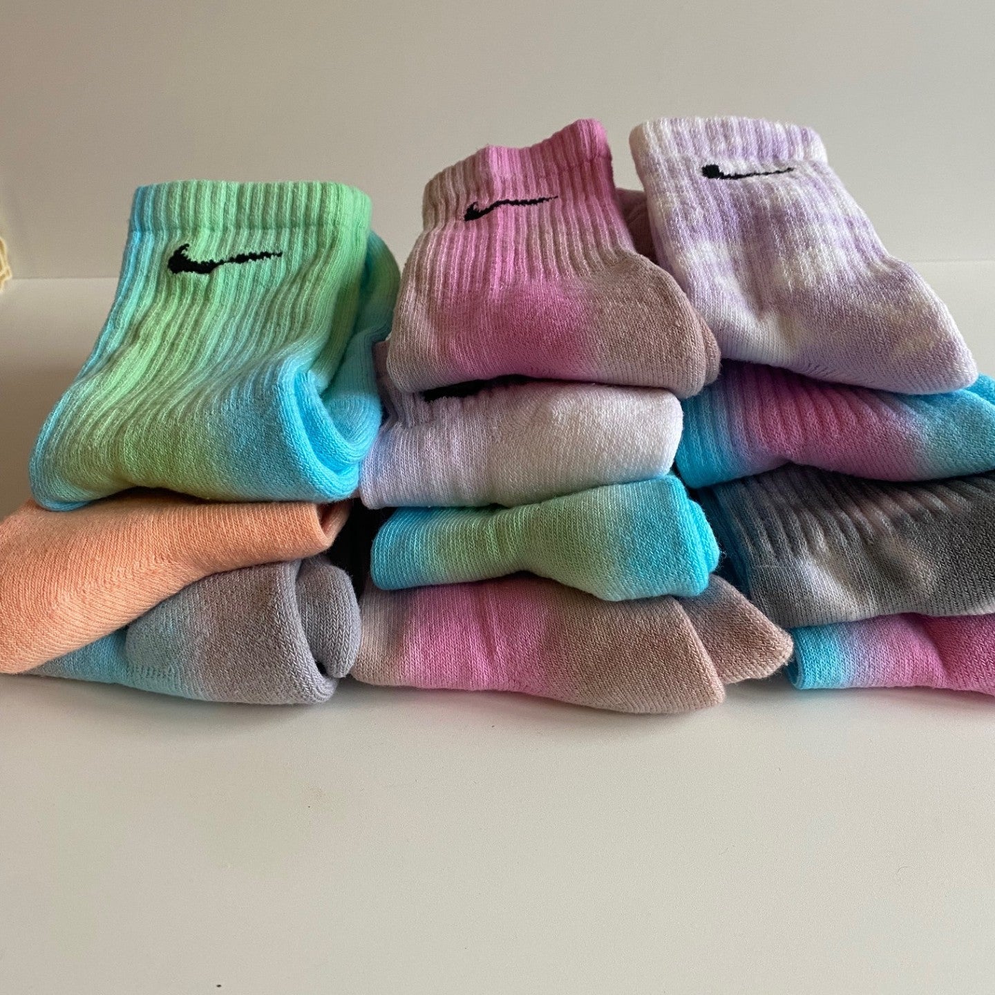 Stack of colorful Nike sock seconds on a light background